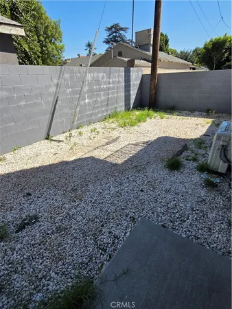 a view of a yard with a wooden fence