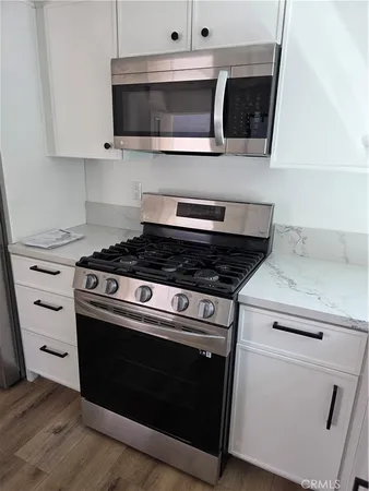 a stove top oven sitting inside of a kitchen