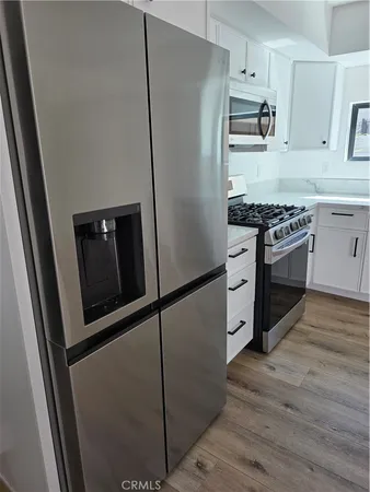 a kitchen with stainless steel appliances a refrigerator stove and sink