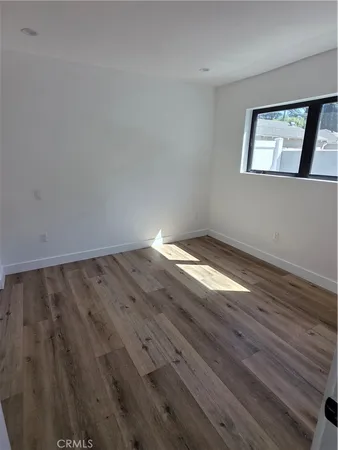 a view of wooden floor and windows in a room