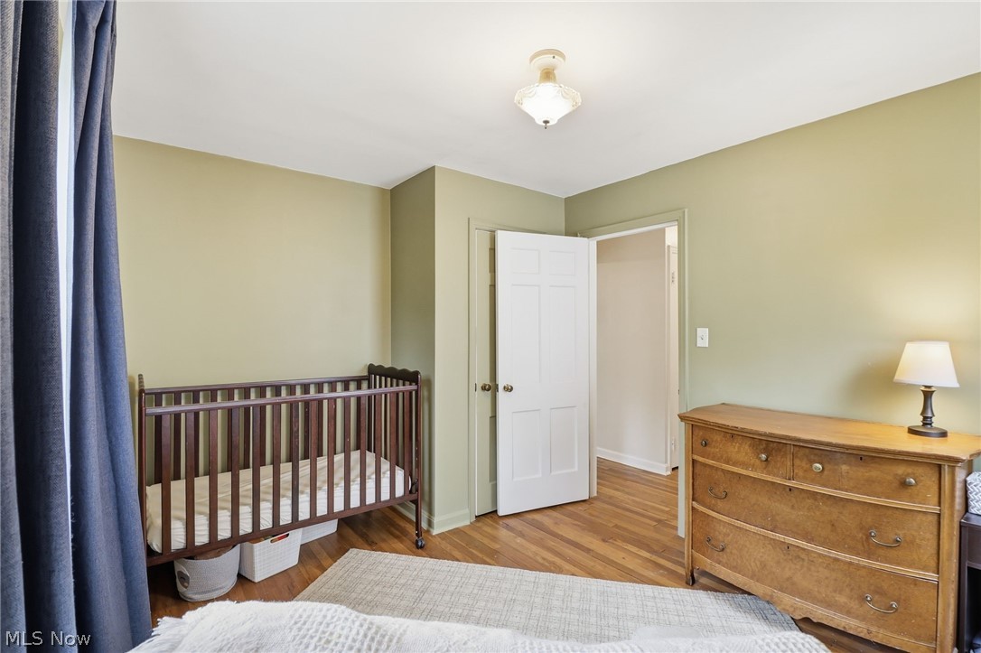 3713 Winchell Road Shaker Heights, OH 44122 - Photo 22 of 38 Interior room featuring wood-finish flooring, light green painted walls, and white trim