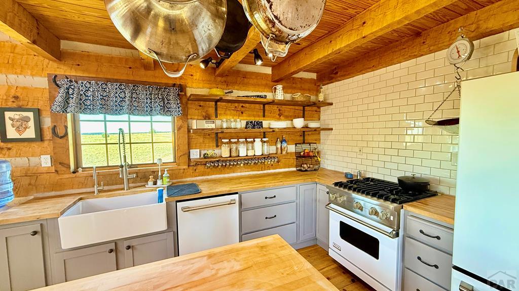 965 Newton Road Pueblo, CO 81005 - Photo 12 of 47 a kitchen that has a sink and a stove