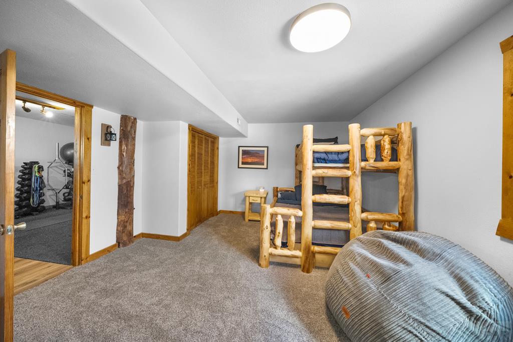 965 Newton Road Pueblo, CO 81005 - Photo 24 of 47 a bed room with a bed and a chair