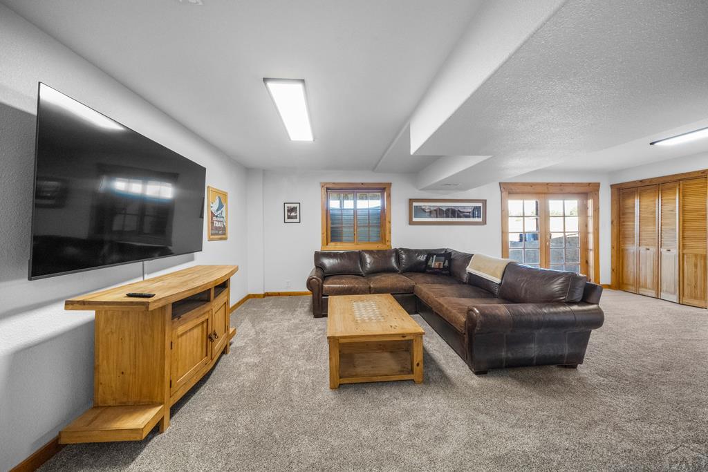 965 Newton Road Pueblo, CO 81005 - Photo 26 of 47 a living room with furniture and a flat screen tv