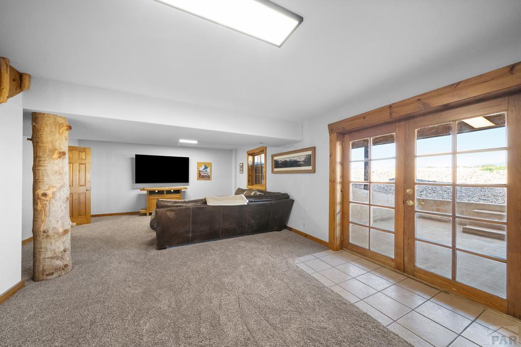 965 Newton Road Pueblo, CO 81005 - Photo 27 of 47 a living room with furniture and a flat screen tv