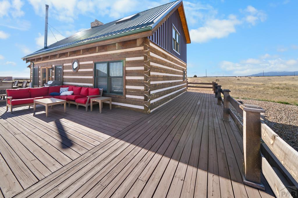 965 Newton Road Pueblo, CO 81005 - Photo 28 of 47 a view of deck with table and chairs with wooden floor and fence