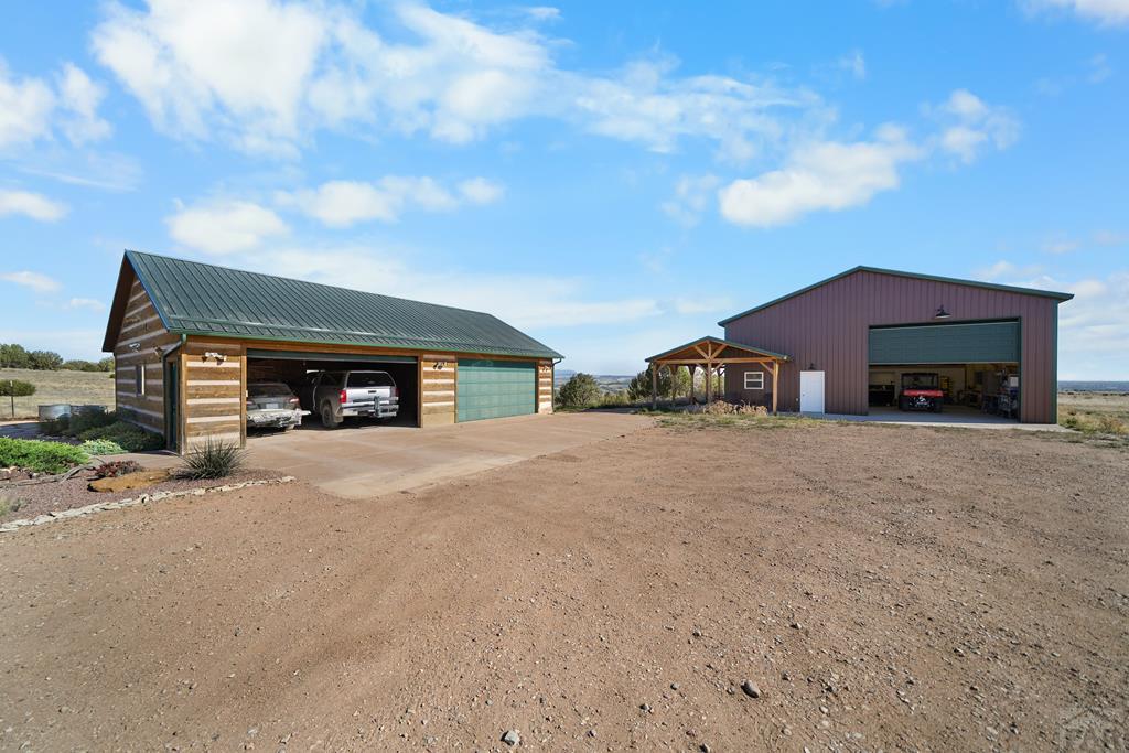 965 Newton Road Pueblo, CO 81005 - Photo 30 of 47 a view of a house with a yard and garage