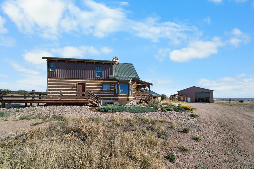 965 Newton Road Pueblo, CO 81005 - Photo 3 of 47 a view of a house with a yard