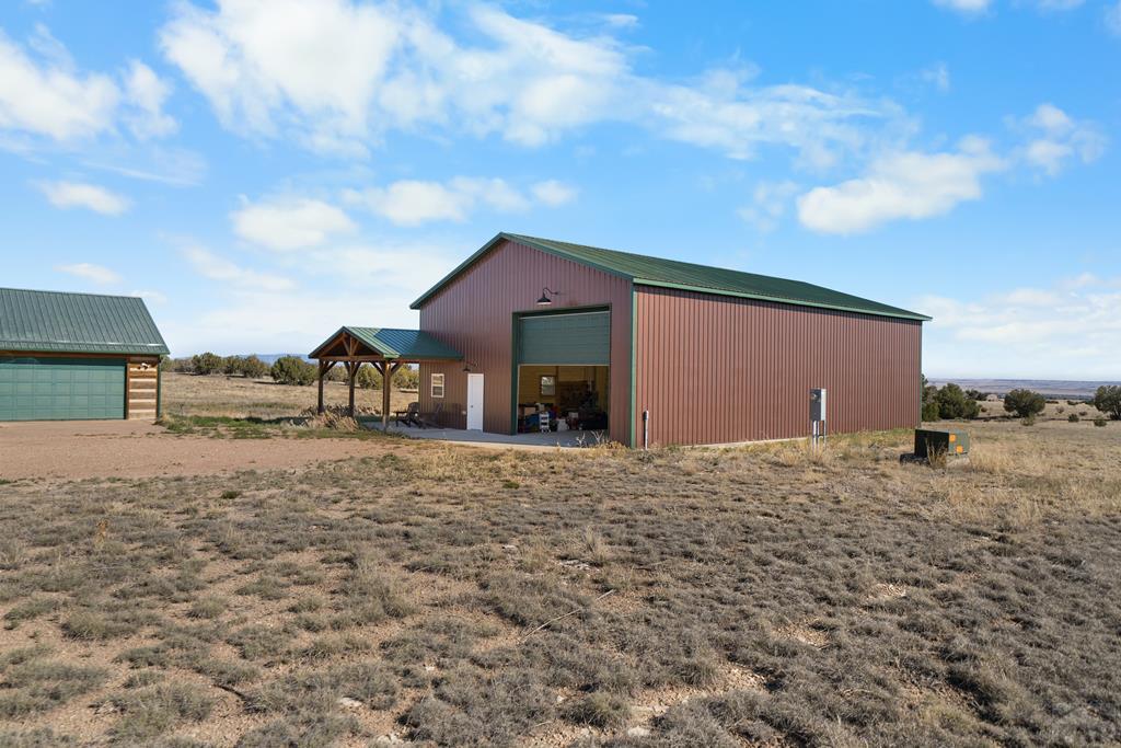 965 Newton Road Pueblo, CO 81005 - Photo 32 of 47 a front view of a house with a yard and garage