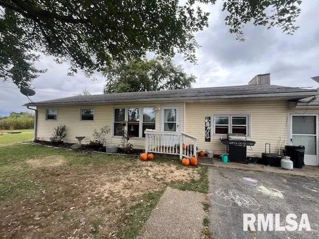 a view of a house with a backyard