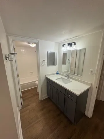 a spacious bathroom with a double vanity sink toilet and shower