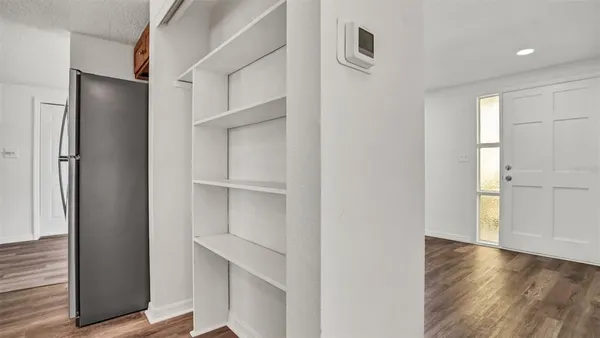 a view of walk in closet with empty racks