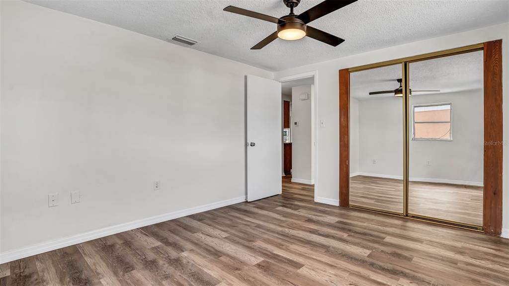 7124 Parrot Drive Port Richey, FL 34668 - Photo 14 of 29 wooden floor in an empty room