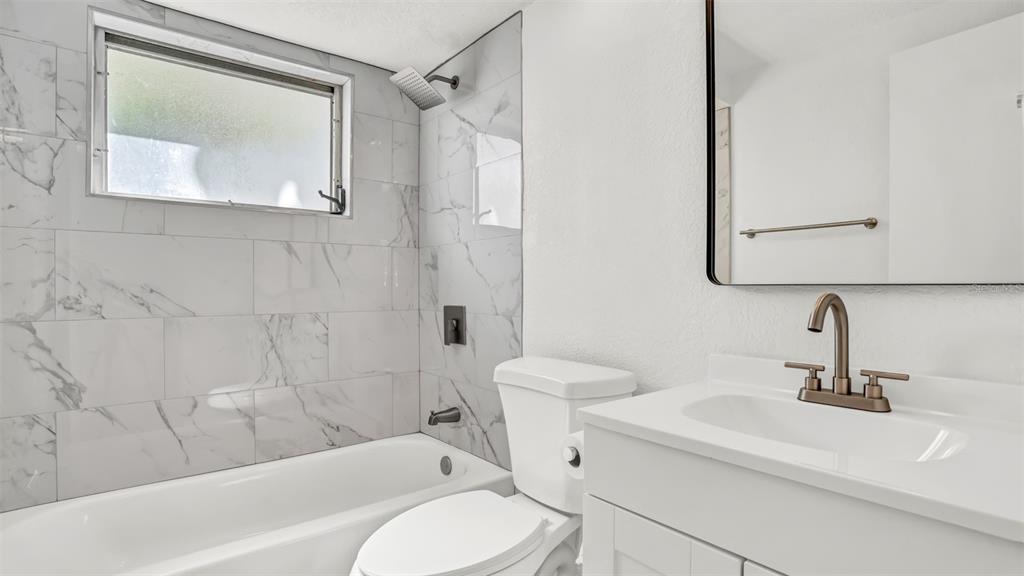 7124 Parrot Drive Port Richey, FL 34668 - Photo 15 of 29 a bathroom with a sink toilet and shower