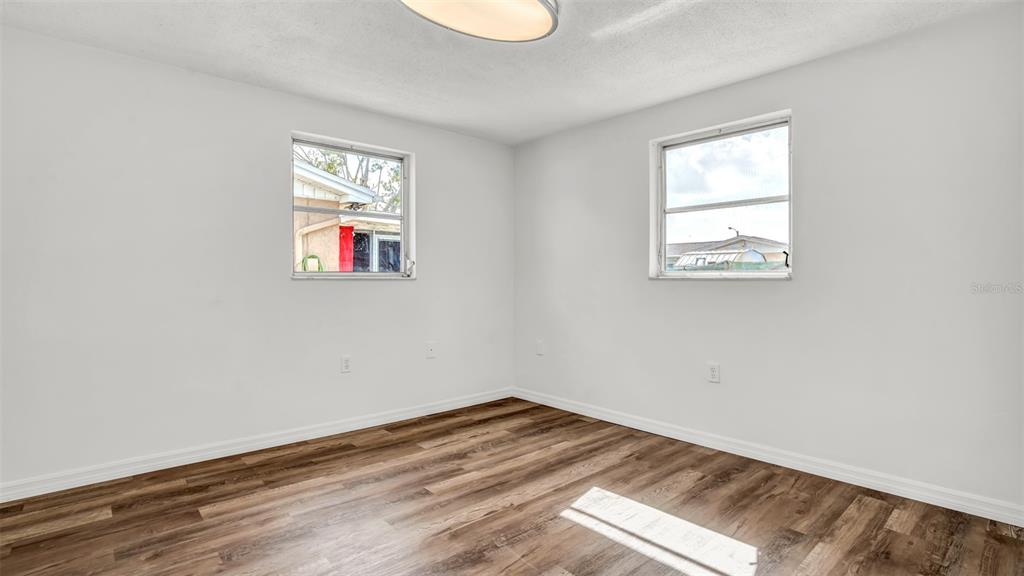 7124 Parrot Drive Port Richey, FL 34668 - Photo 16 of 29 an empty room with windows