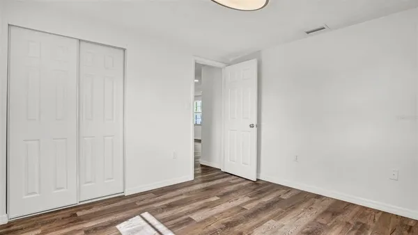 a view of a room with wooden floor