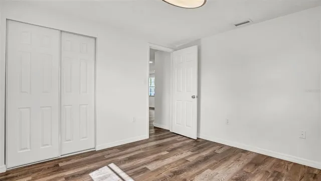 a view of a room with wooden floor