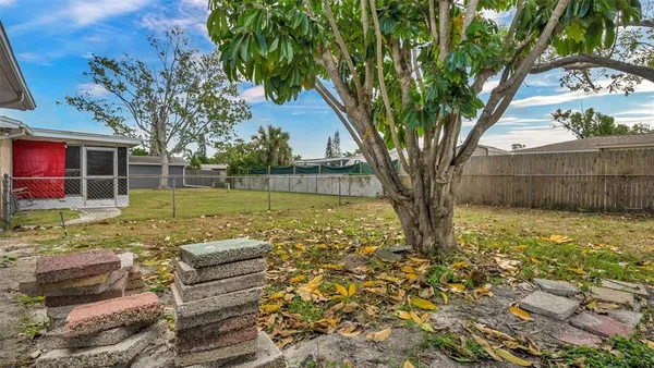 a view of a house with backyard and sitting area