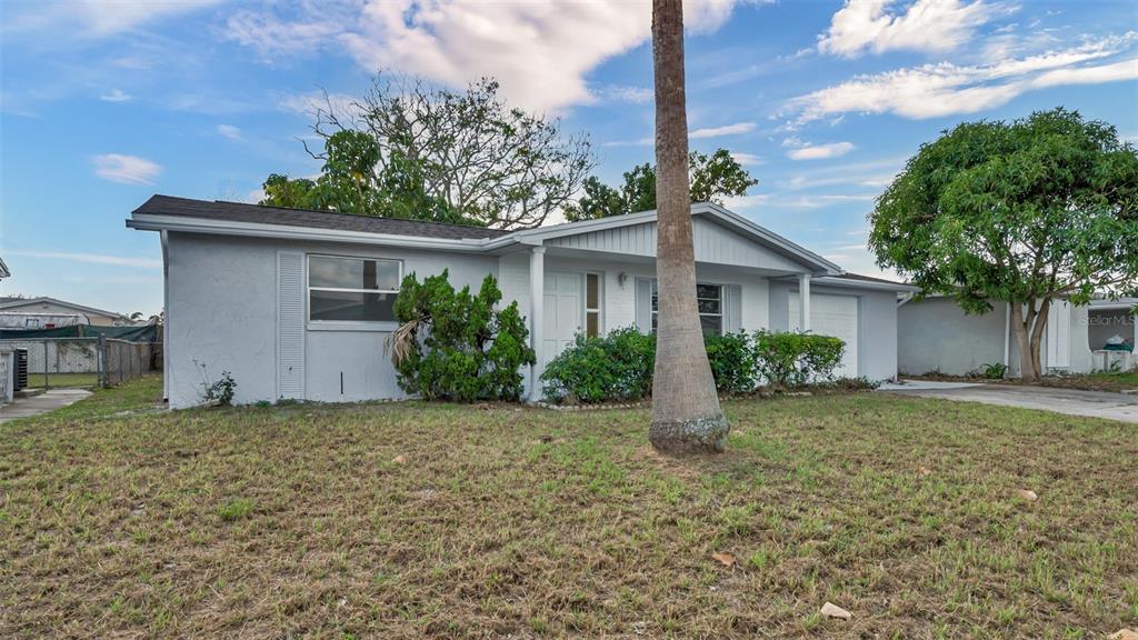 7124 Parrot Drive Port Richey, FL 34668 - Photo 3 of 29 a front view of a house with garden