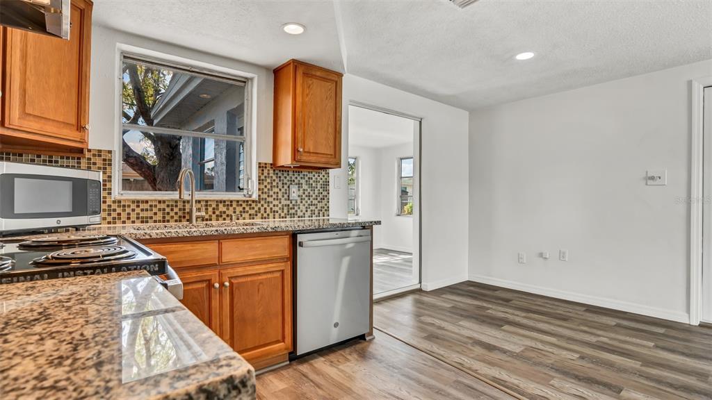 7124 Parrot Drive Port Richey, FL 34668 - Photo 10 of 29 a kitchen that has a sink and a stove in it