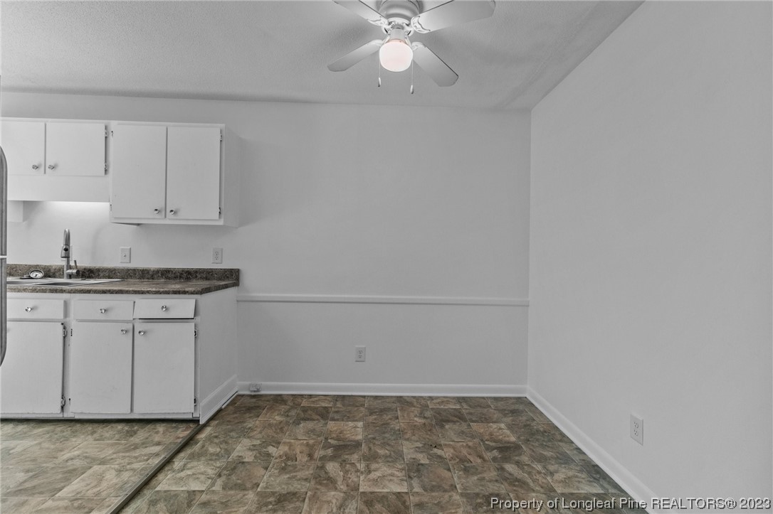 3306 Arrowhead Road Spring Lake, NC 28390 - Photo 11 of 29 a view of kitchen with granite countertop white cabinets and white appliances