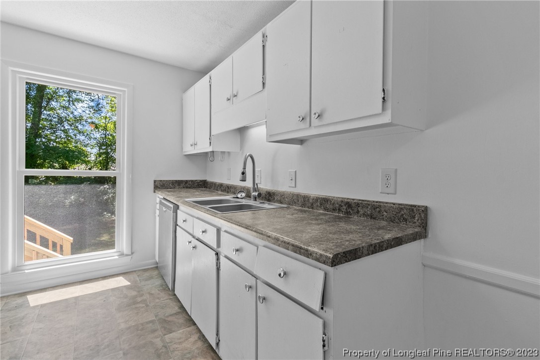 3306 Arrowhead Road Spring Lake, NC 28390 - Photo 12 of 29 a kitchen with granite countertop white cabinets and a window