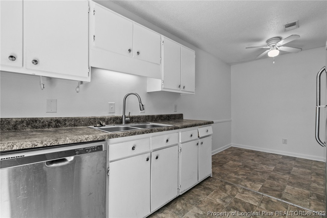 3306 Arrowhead Road Spring Lake, NC 28390 - Photo 13 of 29 a kitchen with granite countertop white cabinets and white appliances