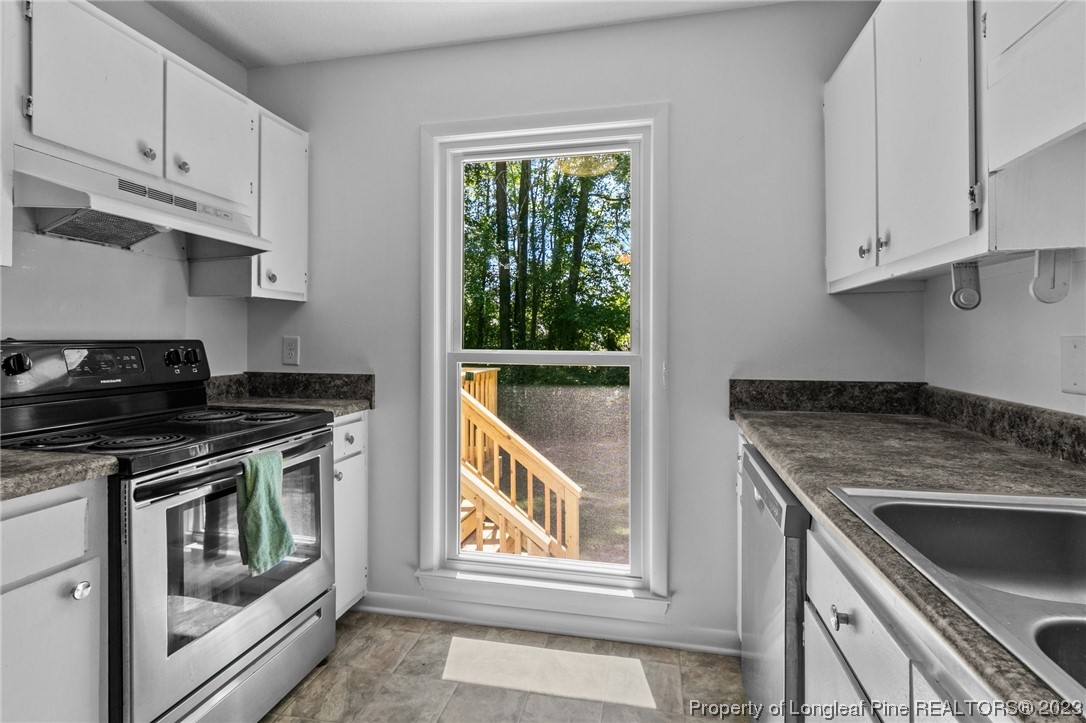 3306 Arrowhead Road Spring Lake, NC 28390 - Photo 14 of 29 a kitchen with granite countertop a stove and a sink