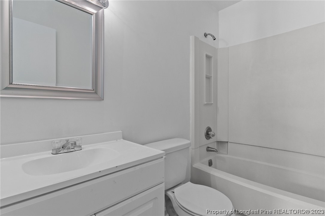 3306 Arrowhead Road Spring Lake, NC 28390 - Photo 17 of 29 a bathroom with a sink toilet vanity and bathtub