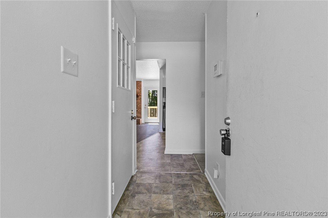 3306 Arrowhead Road Spring Lake, NC 28390 - Photo 5 of 29 a view of a hallway with wooden floor and a bathroom