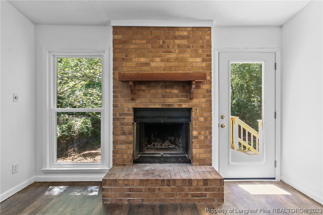 3306 Arrowhead Road Spring Lake, NC 28390 - Photo 6 of 29 a living room with a fireplace and a window
