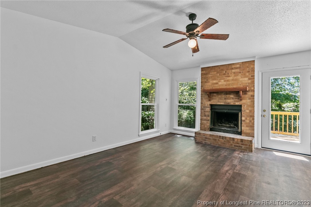 3306 Arrowhead Road Spring Lake, NC 28390 - Photo 7 of 29 wooden floor in an empty room with a fireplace