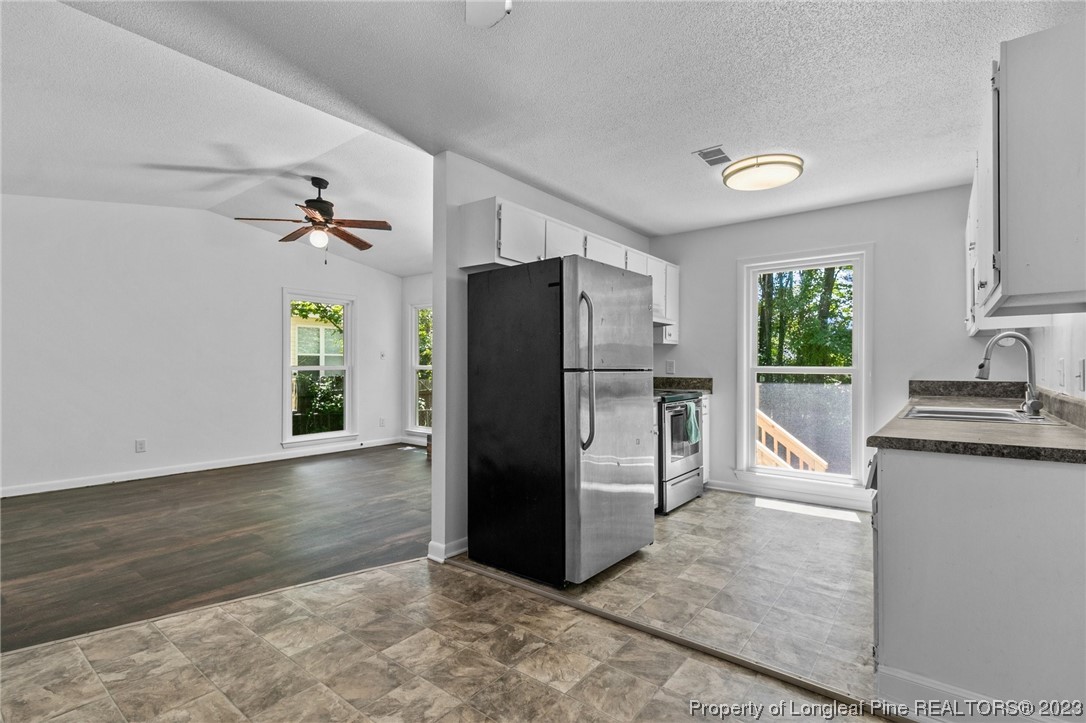 3306 Arrowhead Road Spring Lake, NC 28390 - Photo 10 of 29 a kitchen with granite countertop a refrigerator and a sink