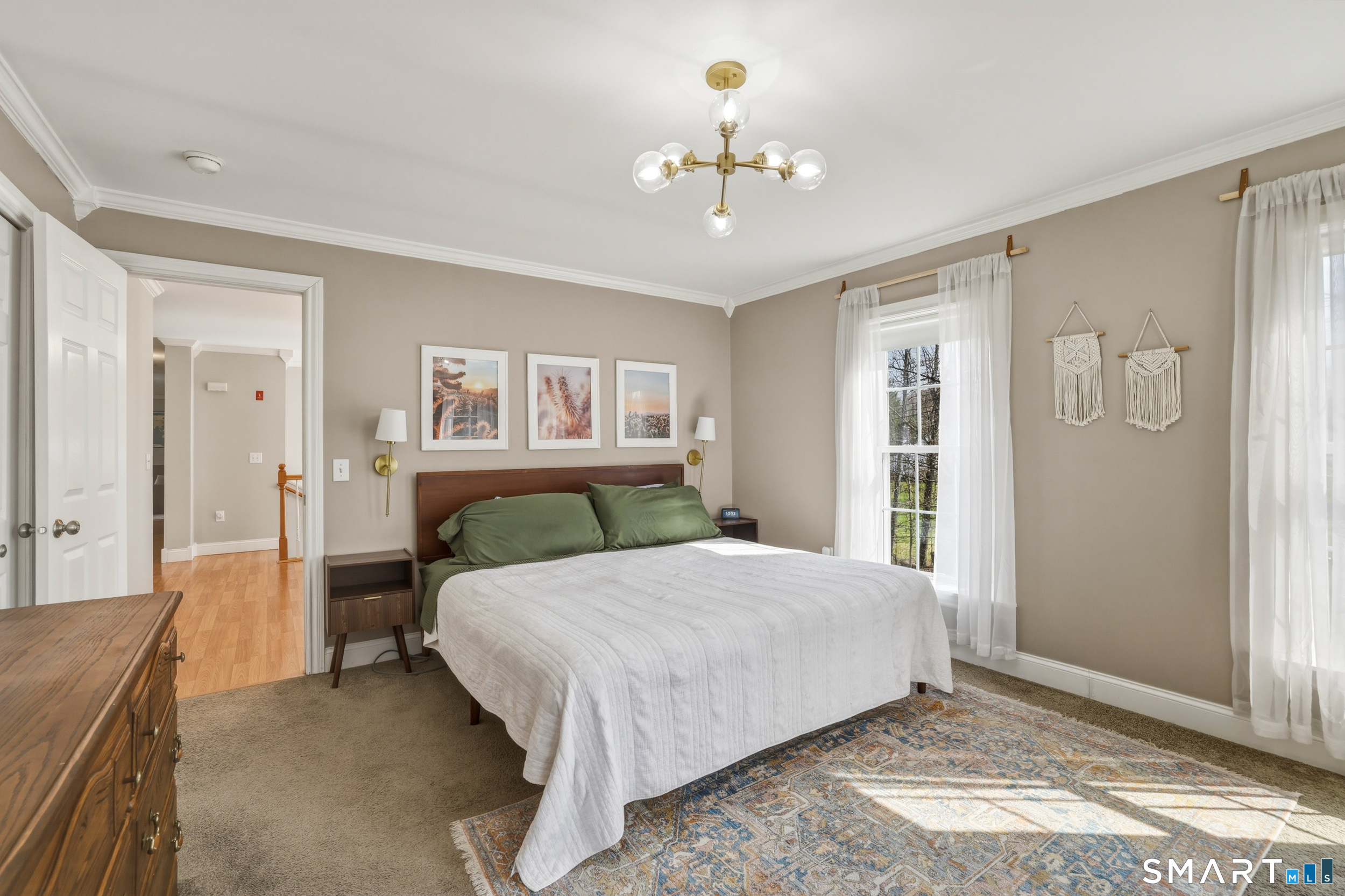 129 North Mountain Road Canton, CT 06019 - Photo 16 of 39 a bedroom with a large bed and a chandelier