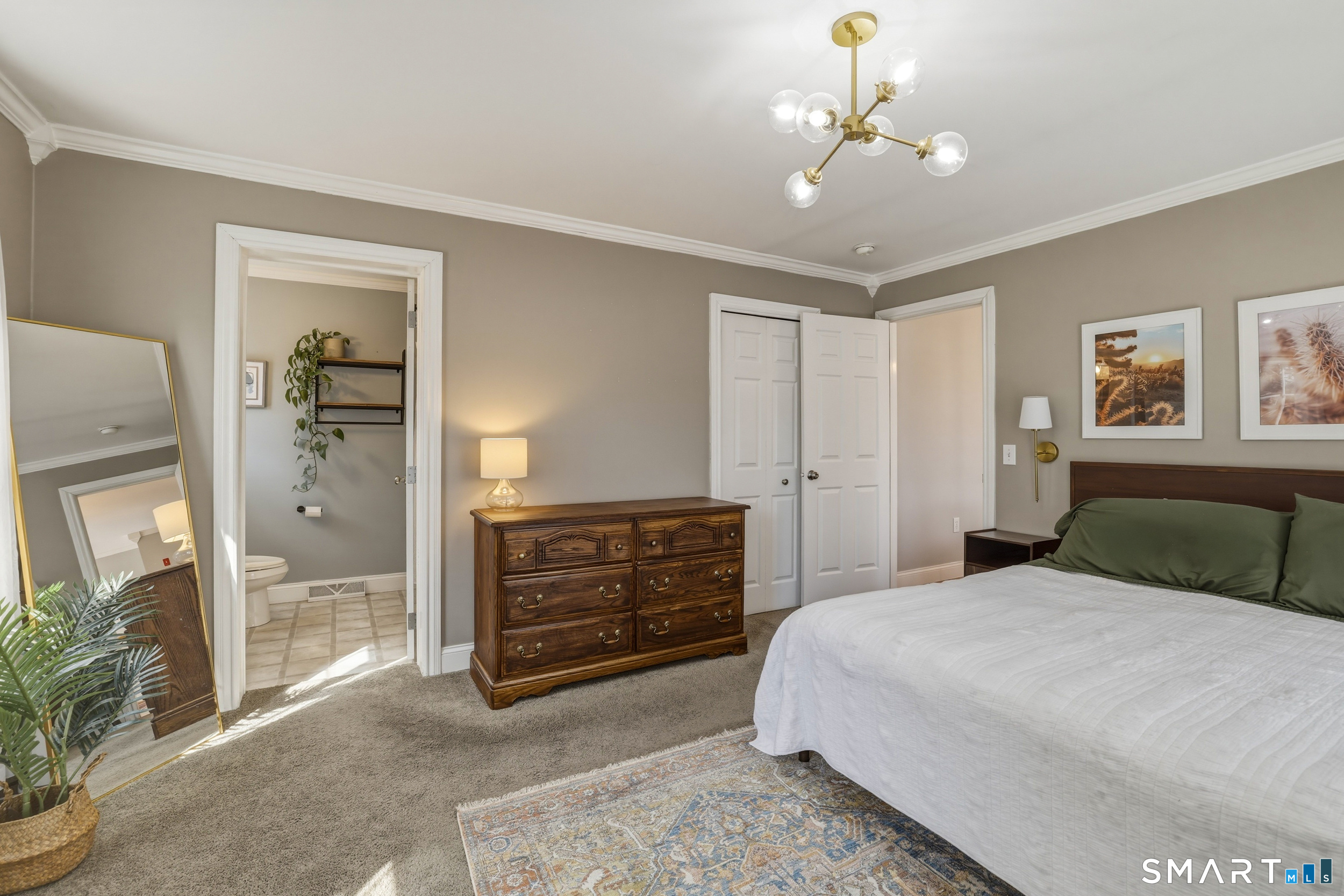129 North Mountain Road Canton, CT 06019 - Photo 17 of 39 a bedroom with a bed and a chandelier