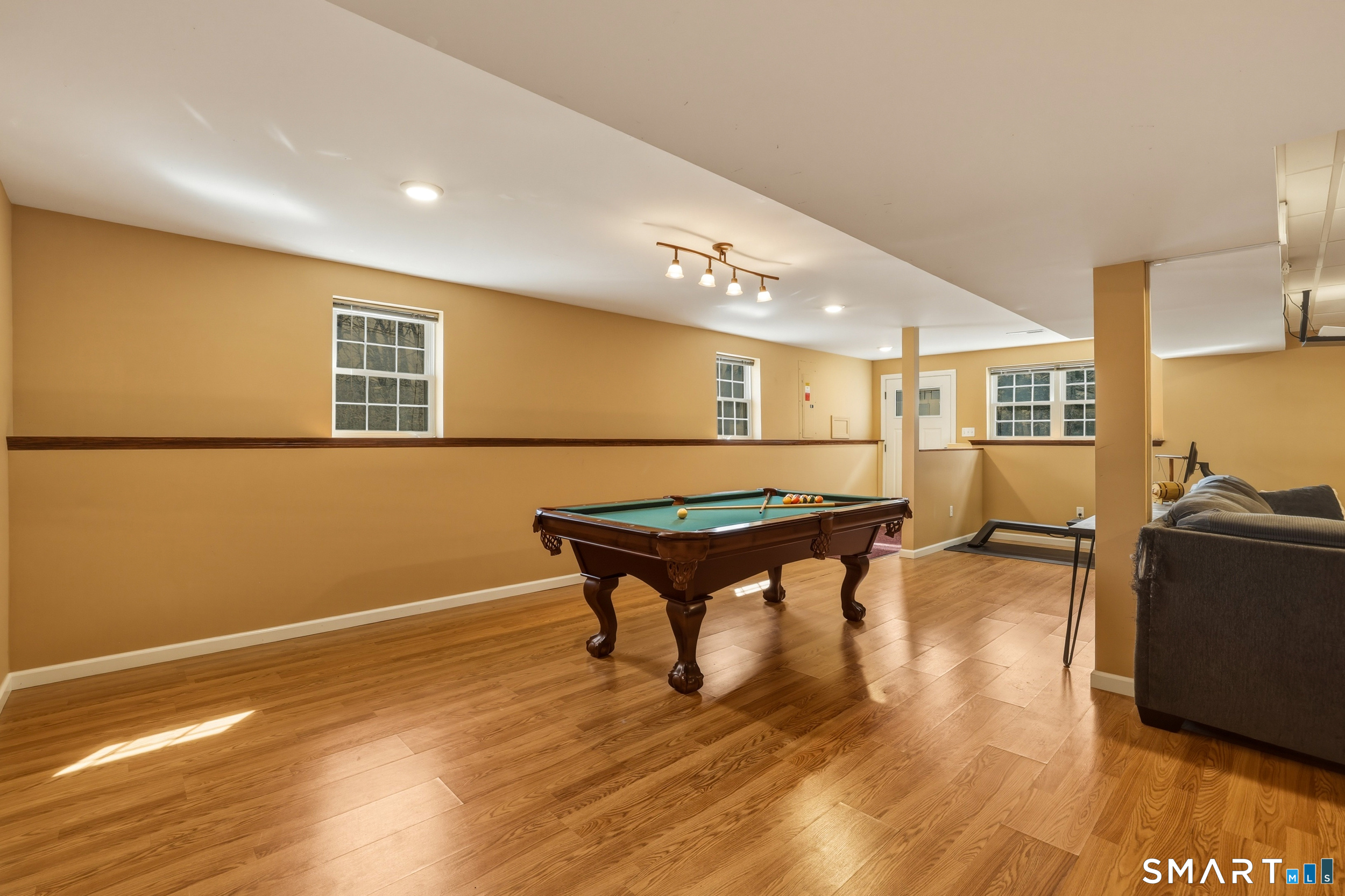 129 North Mountain Road Canton, CT 06019 - Photo 28 of 39 a room with wooden floor pool table and windows