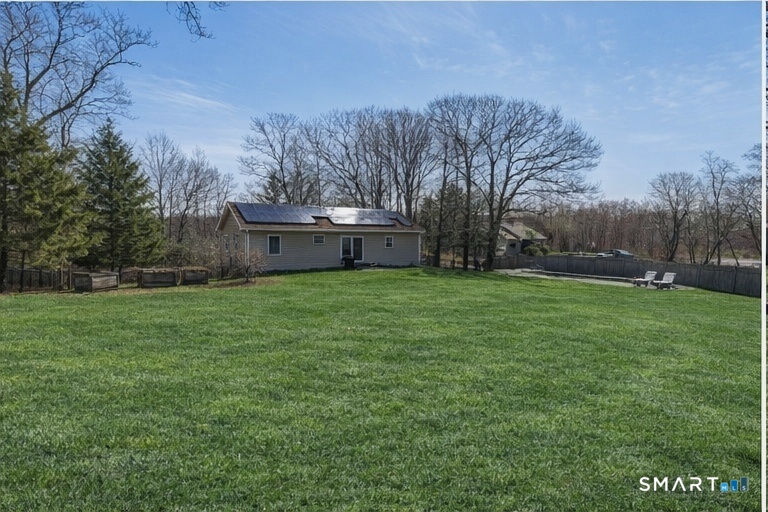 129 North Mountain Road Canton, CT 06019 - Photo 37 of 39 a view of a white house with a big yard and large trees