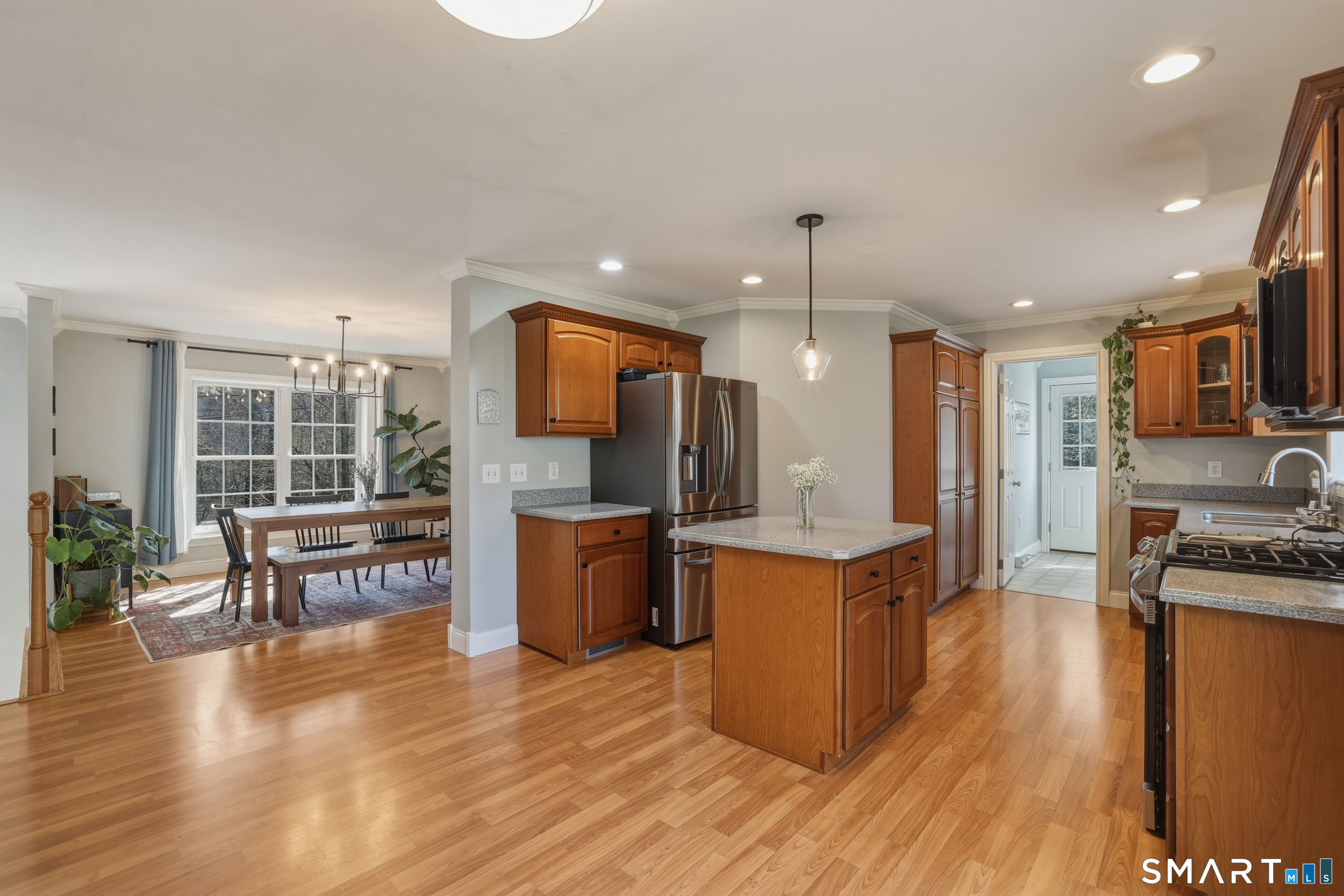 129 North Mountain Road Canton, CT 06019 - Photo 6 of 39 a kitchen with stainless steel appliances granite countertop a refrigerator a stove top oven a sink dishwasher and couches with wooden floor