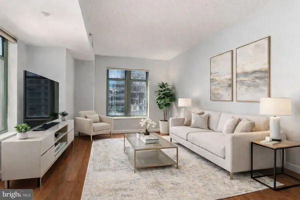 a living room with furniture flat screen tv and a large window