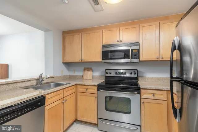 a kitchen with a refrigerator sink and stove