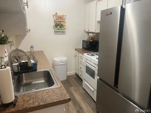 a kitchen with a refrigerator sink and stove