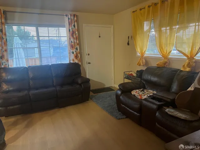 a living room with furniture and a window
