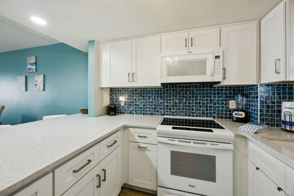 3350 South Fletcher Avenue, Unit 5D Fernandina Beach, FL 32034 - Photo 12 of 48 a kitchen with a sink stove and cabinets