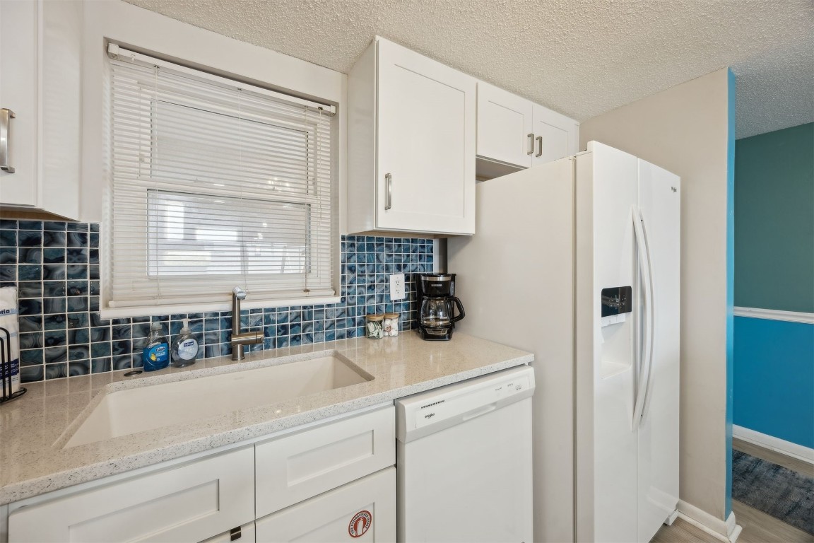 3350 South Fletcher Avenue, Unit 5D Fernandina Beach, FL 32034 - Photo 14 of 48 a kitchen with a refrigerator a sink and cabinets