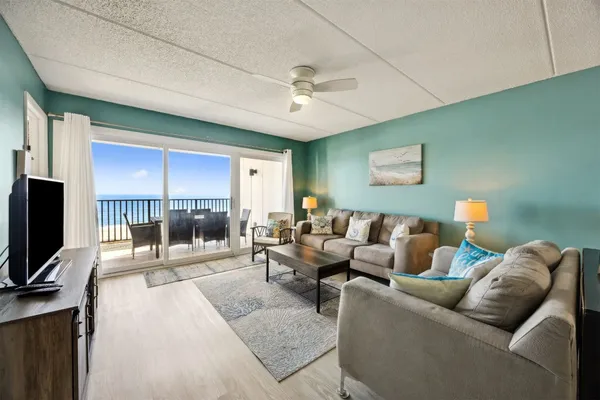 a living room with furniture and a flat screen tv