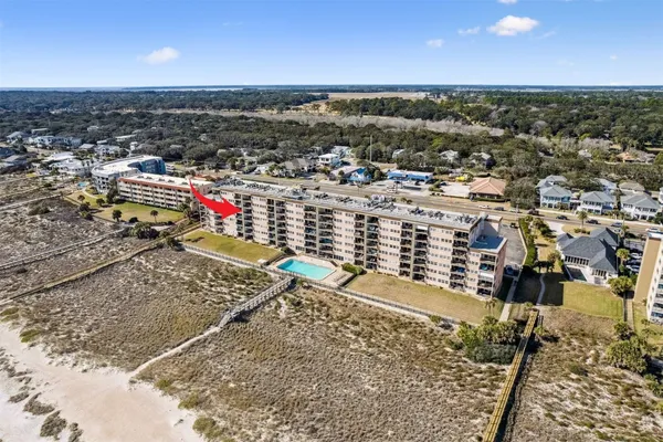 an aerial view of residential building and ocean view
