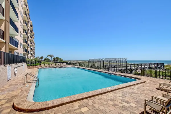 a view of swimming pool with outdoor seating and city view