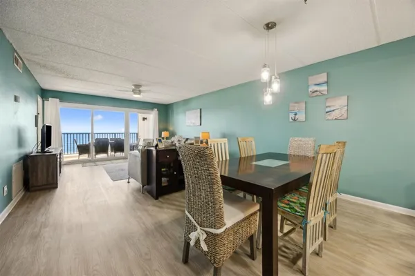a view of a dining room with furniture and wooden floor