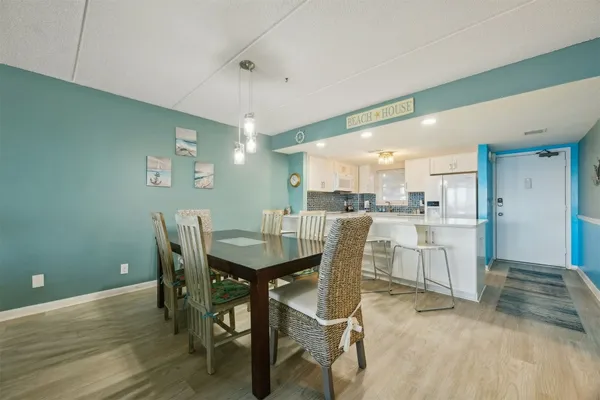 a large white kitchen with a table and chairs