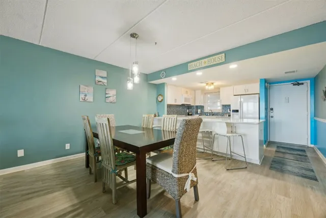 a large white kitchen with a table and chairs